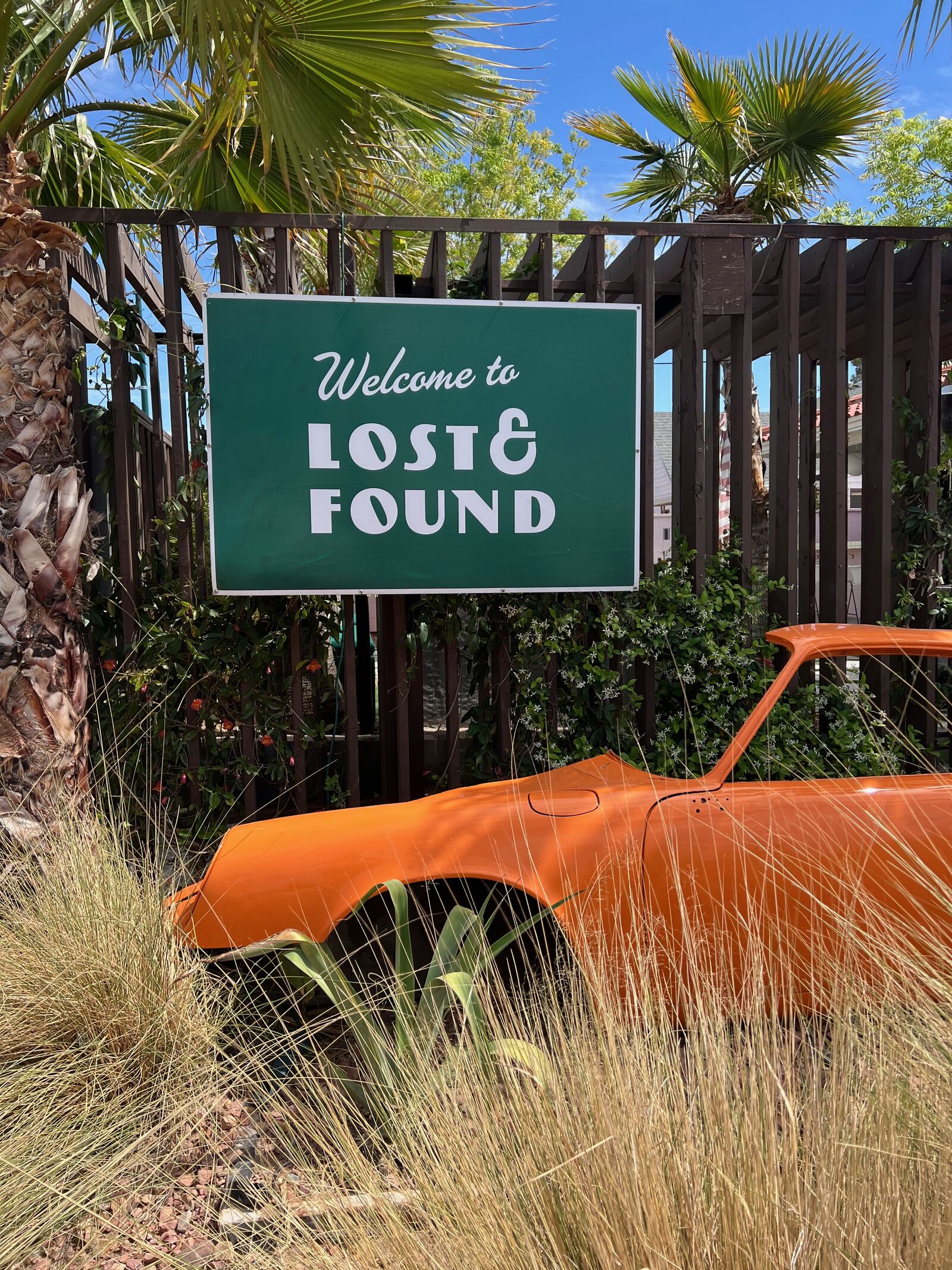 Lost and Found sign with rusted car