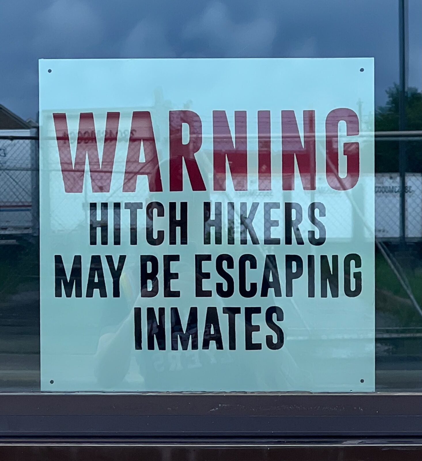 Warning hitch hikers may be escaping inmates sign