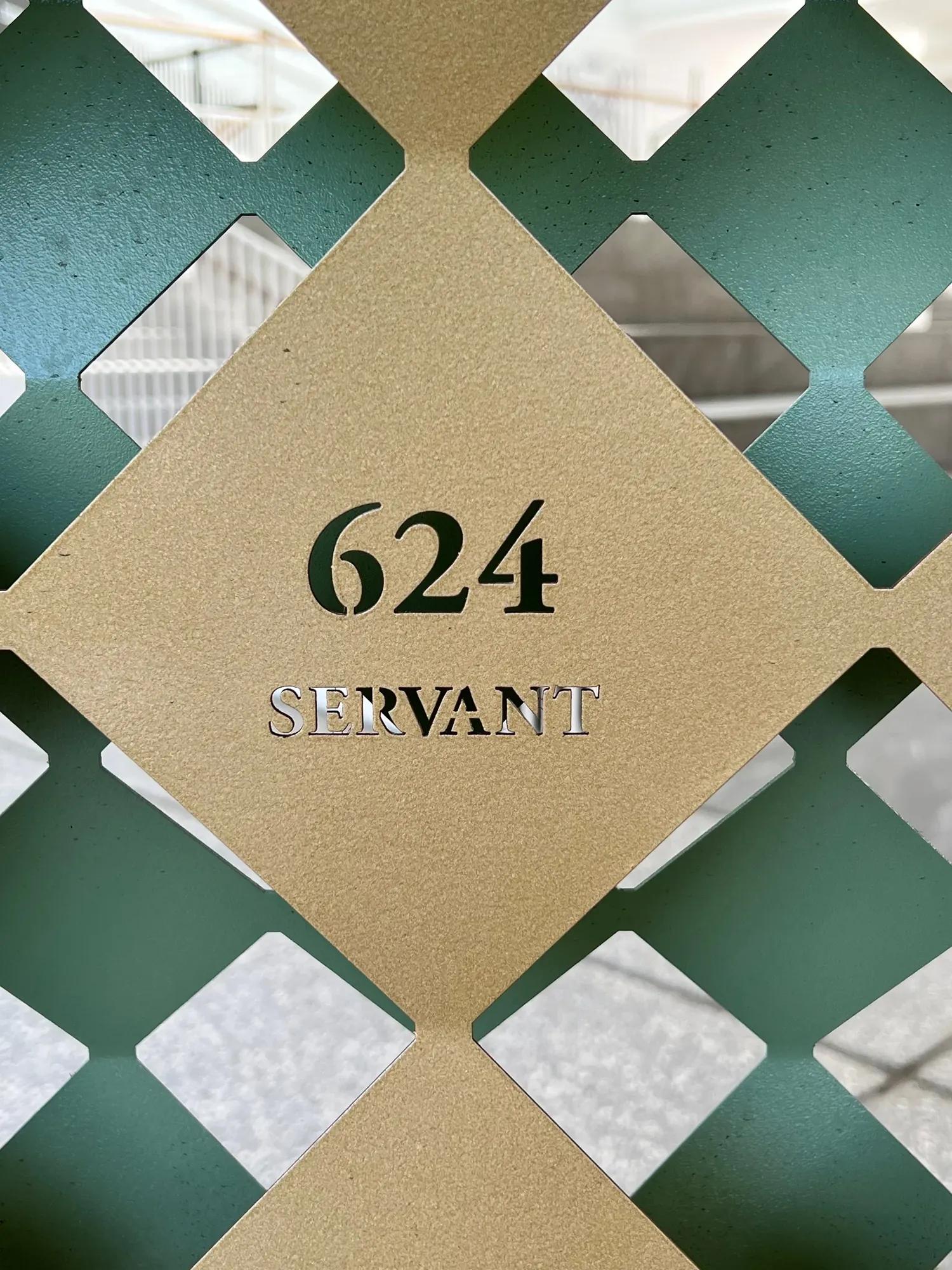 A house number and street name plaque set into a wrought-iron gate, Charleston