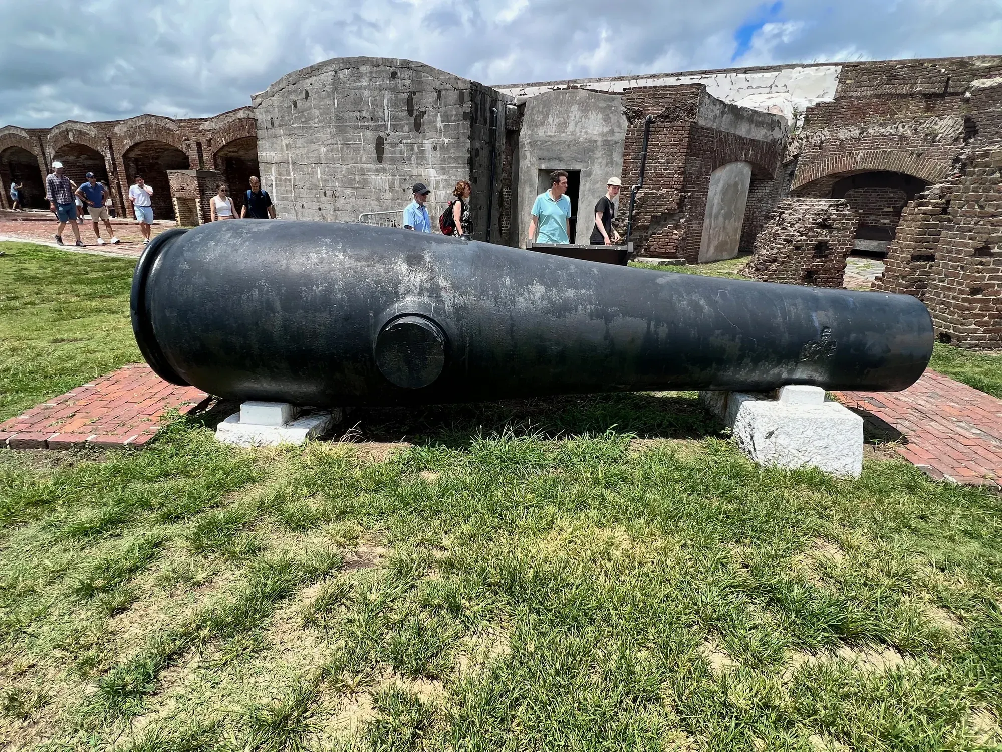 A cannon set against the ruined brick walls of Fort Sumter