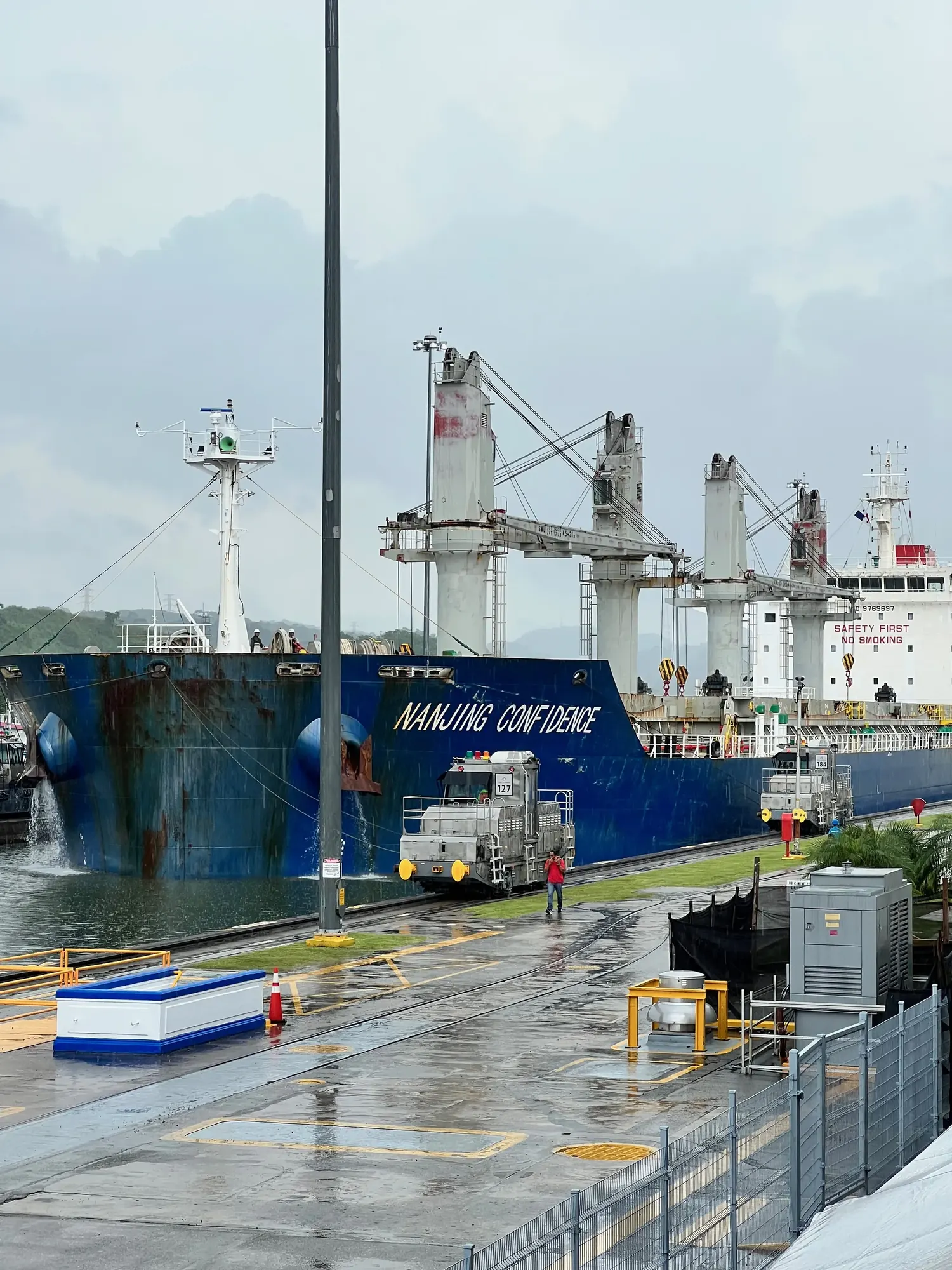 The container ship Nanjing Confidence passing through the Panama Canal's Miraflores Locks in the rain
