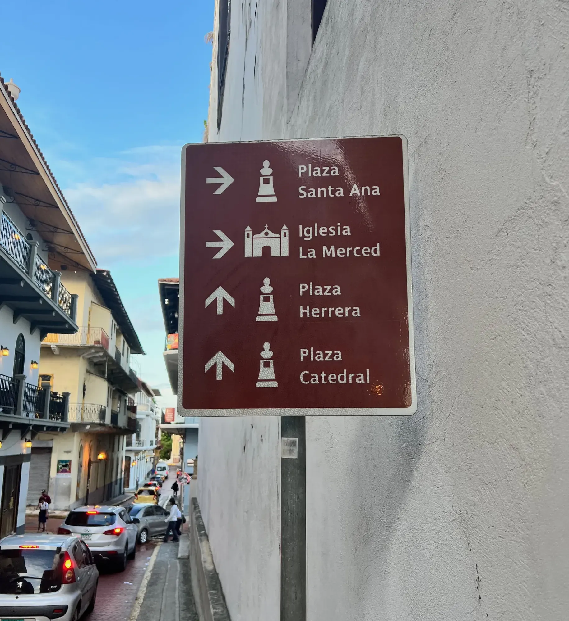A wayfinding sign pointing to plazas and churches in Casco Viejo