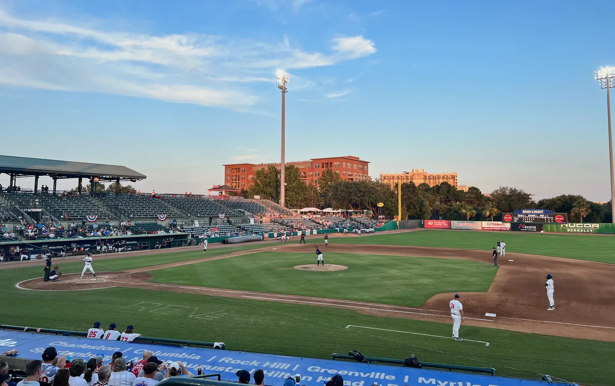 A wide view of the RiverDogs game at Joseph P. Riley Jr. Park, Charleston, with the city skyline behind the outfield