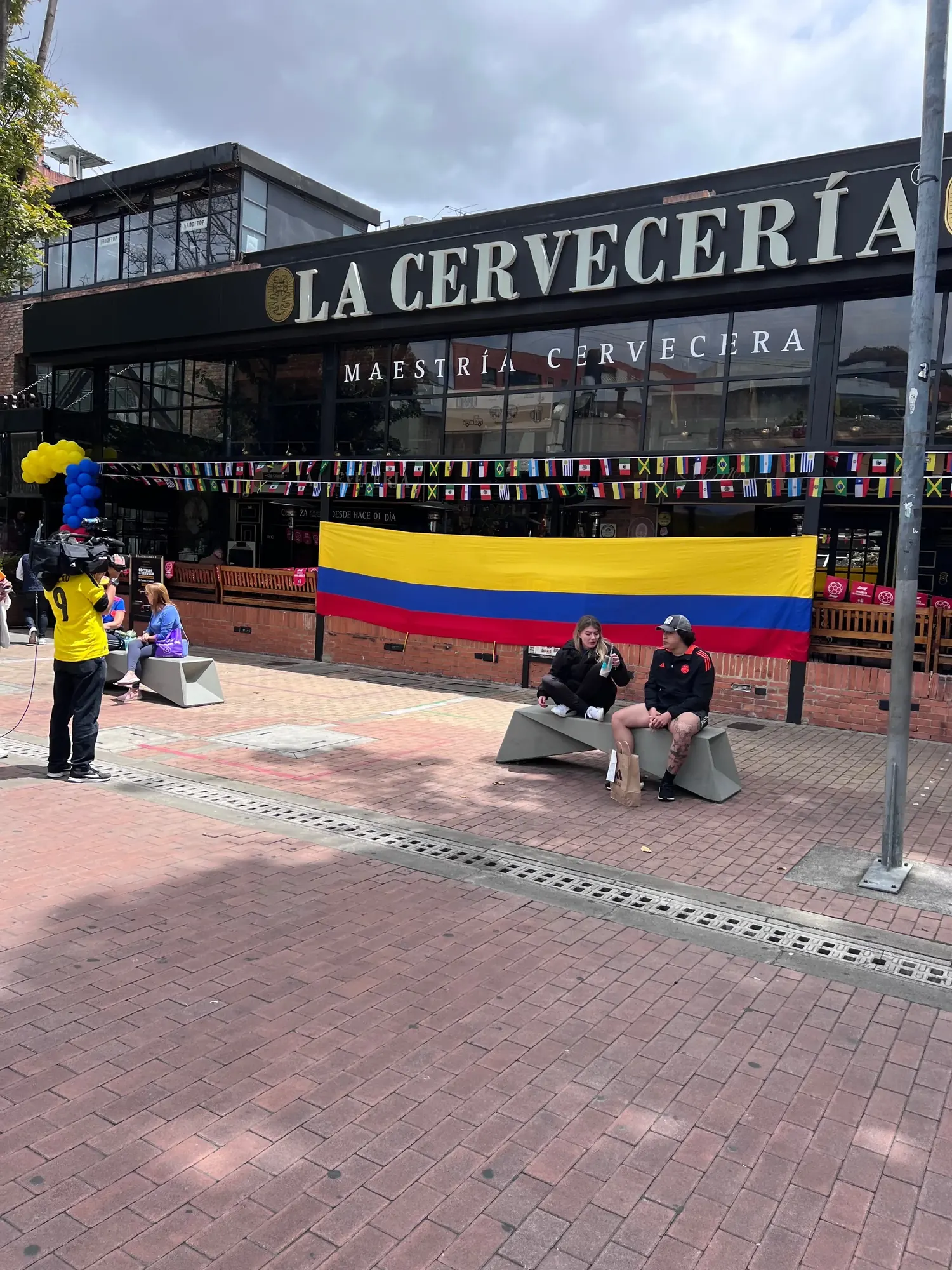 La Cerveceria bar decorated with a large Colombia flag and international flags ahead of the Copa America final